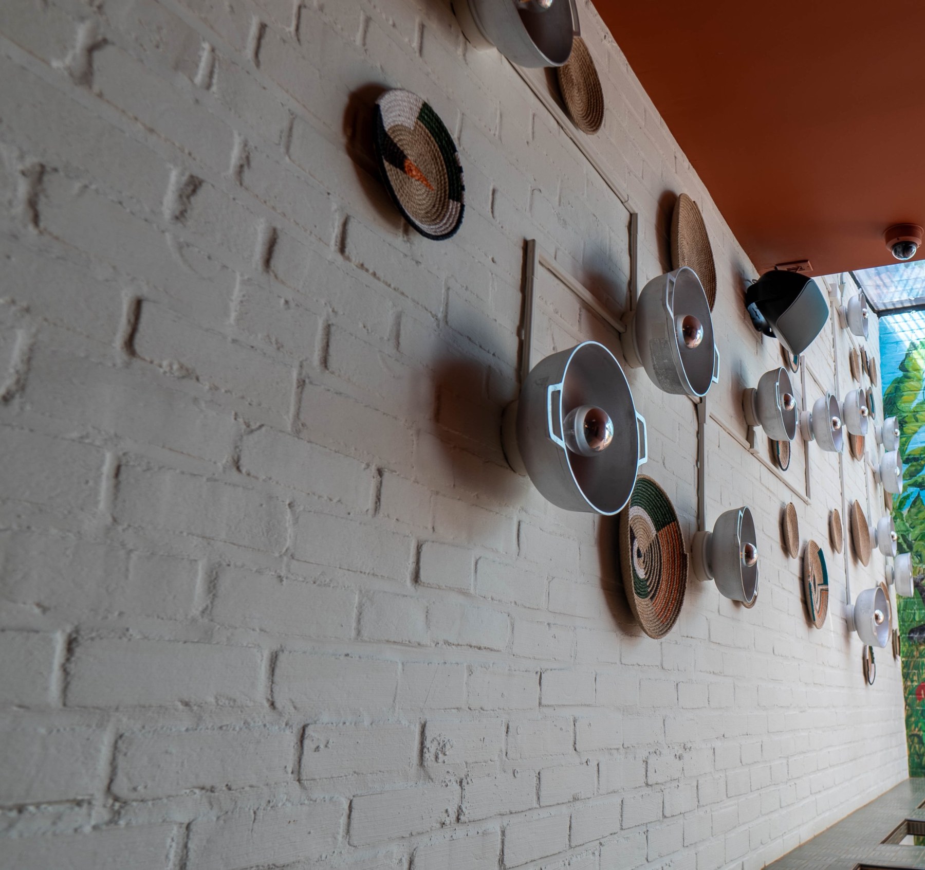 Dutch pot installation on a painted brick wall, Jumieka Grand